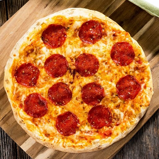 Pepperoni pizza on rustic background